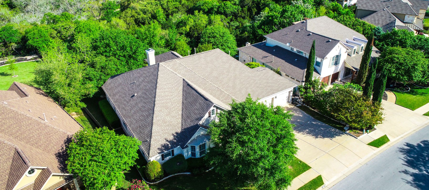 aerial view of two homes in a live oak neighborhood