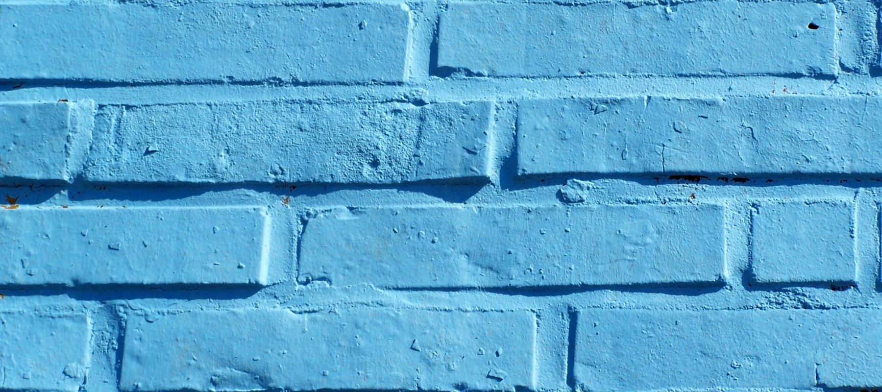 four rows of brick painted a shade of light blue